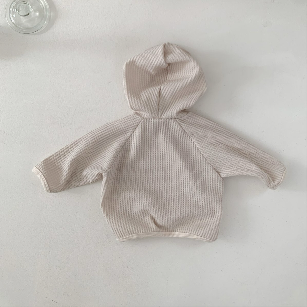 Cozy Monica Hoodie in beige waffle texture, perfect for babies and toddlers, blending style and functionality.