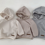 Monica Hoodie in soft neutral colors, featuring cozy waffle texture, perfect for babies and toddlers.