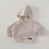 Monica Hoodie in soft beige waffle texture, perfect for babies and toddlers, combines style and functionality.