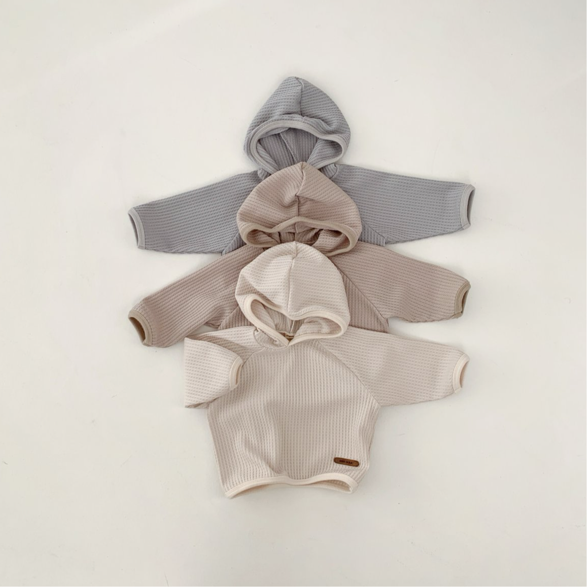 Cozy Monica Hoodie in neutral colors, perfect for babies and toddlers, showcasing stylish waffle texture.